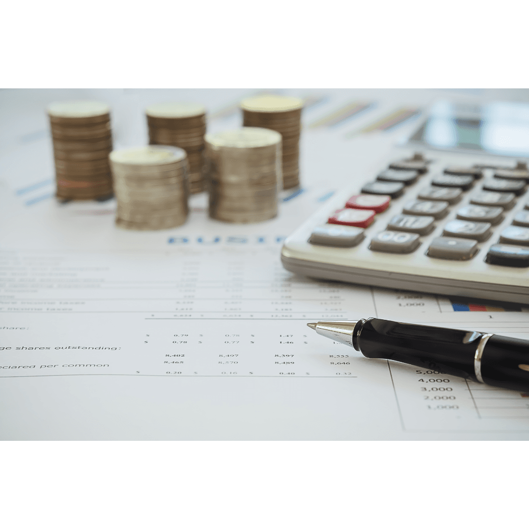 Financial planning with a calculator, coin stacks, and budget documents.