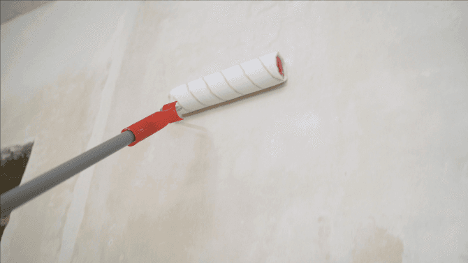 Applying primer on wall