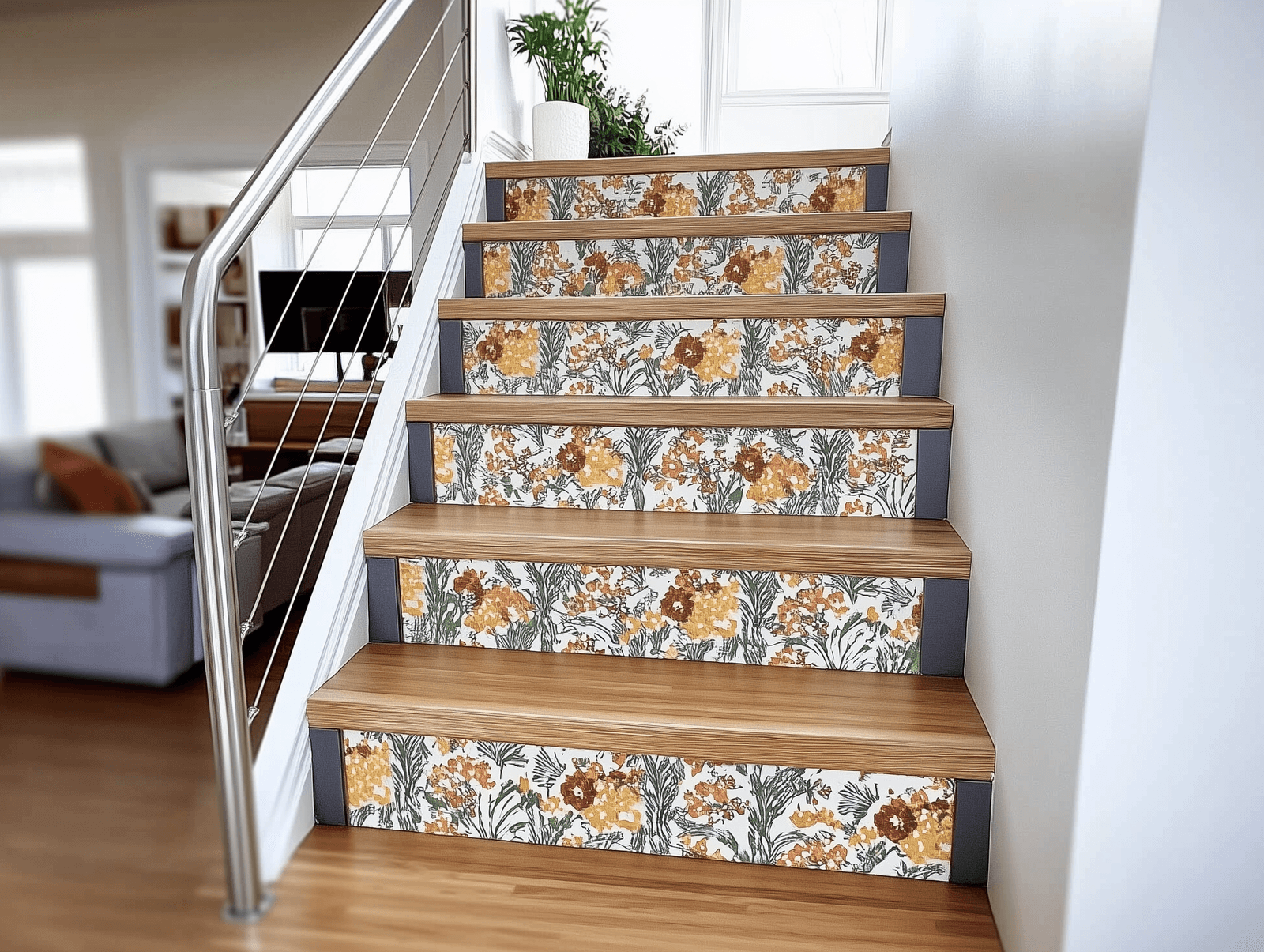 Wooden staircase with risers decorated with colorful floral patterns in a bright, modern house.