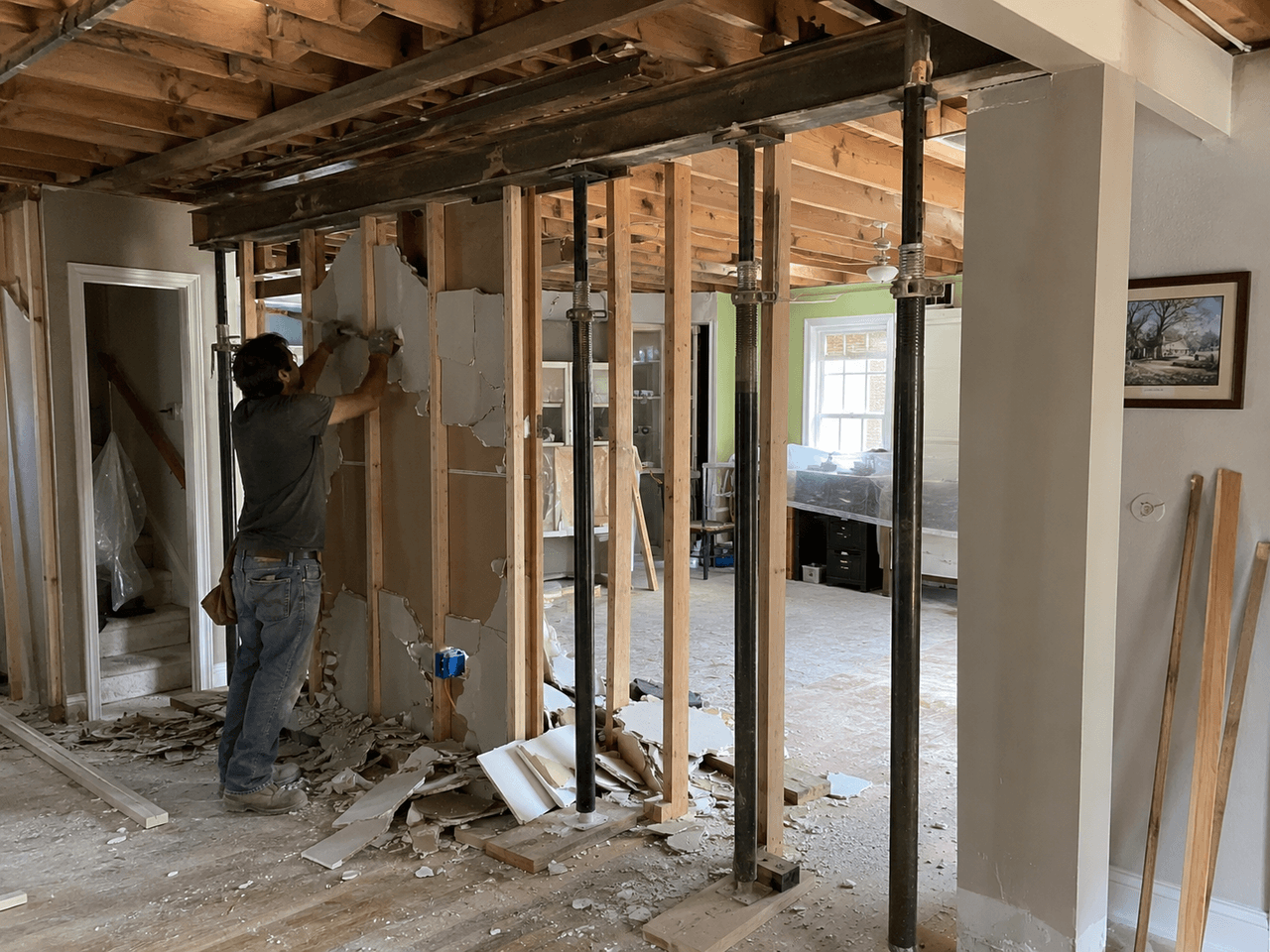 Interior demolition with wall removal, steel beam, temporary supports and exposed framing