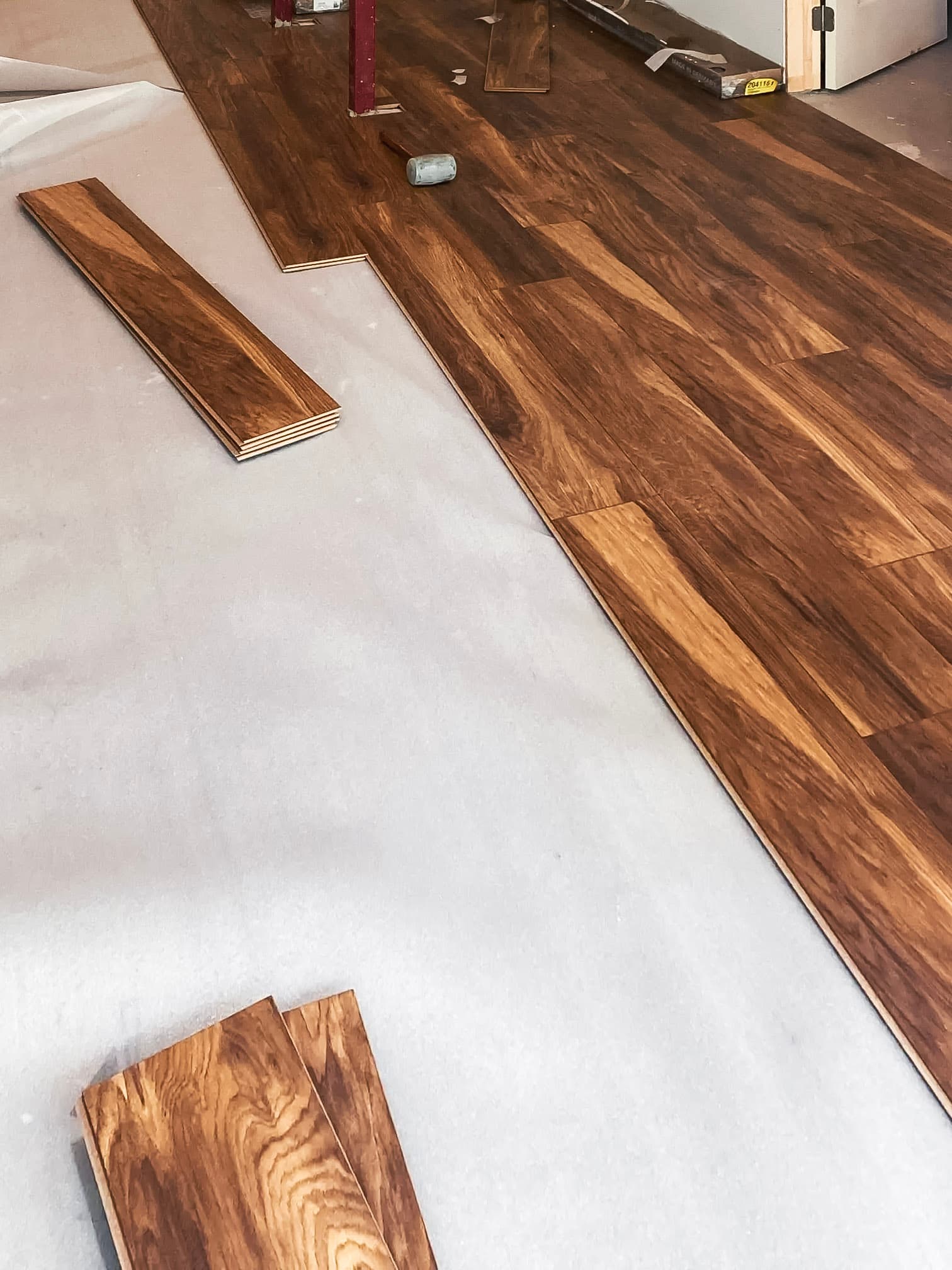Wooden floor installation in a residential home under renovation.<br>