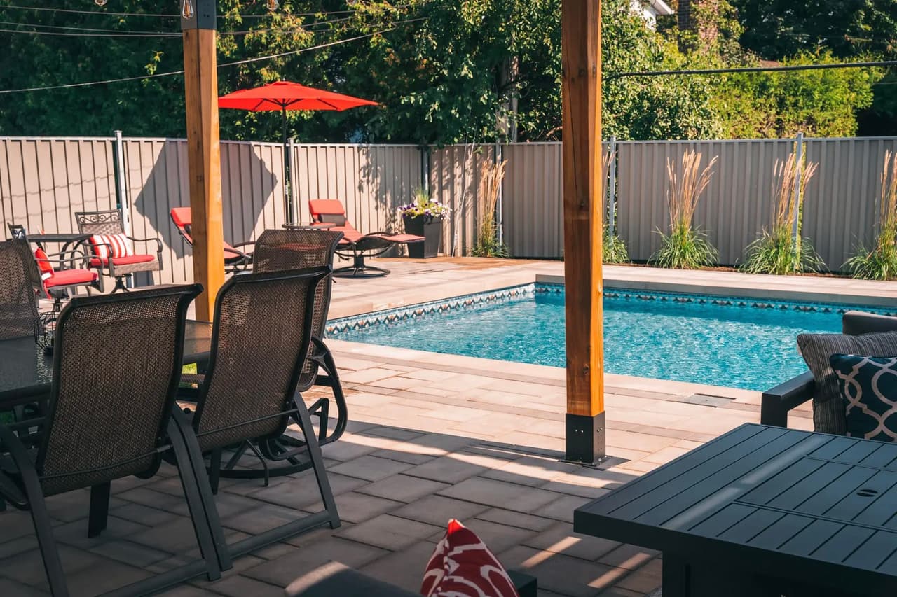 Modern patio with outdoor furniture, in-ground pool, and fenced landscaping