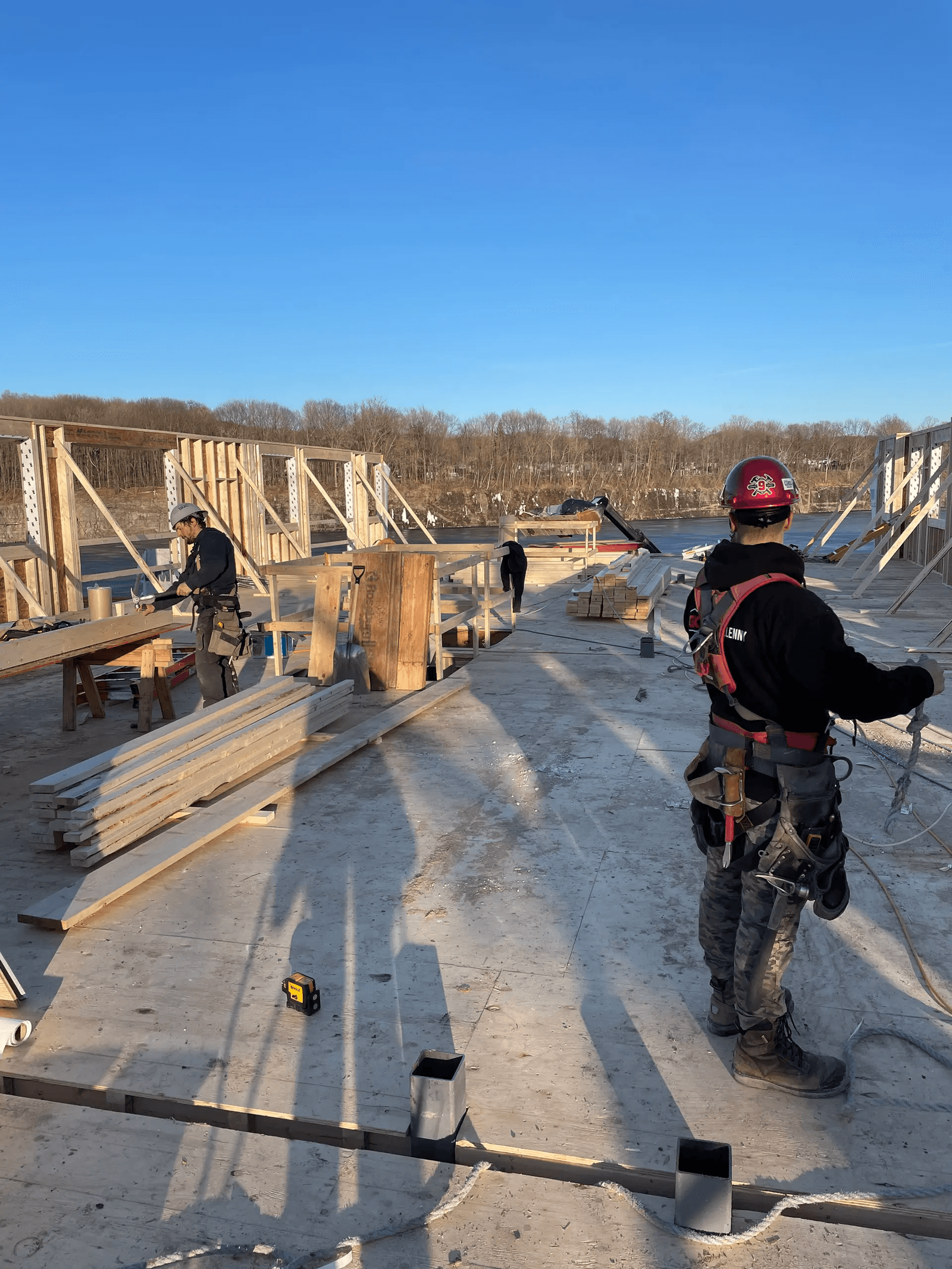 Construction workers on a wood framing site at the early stage of a house build