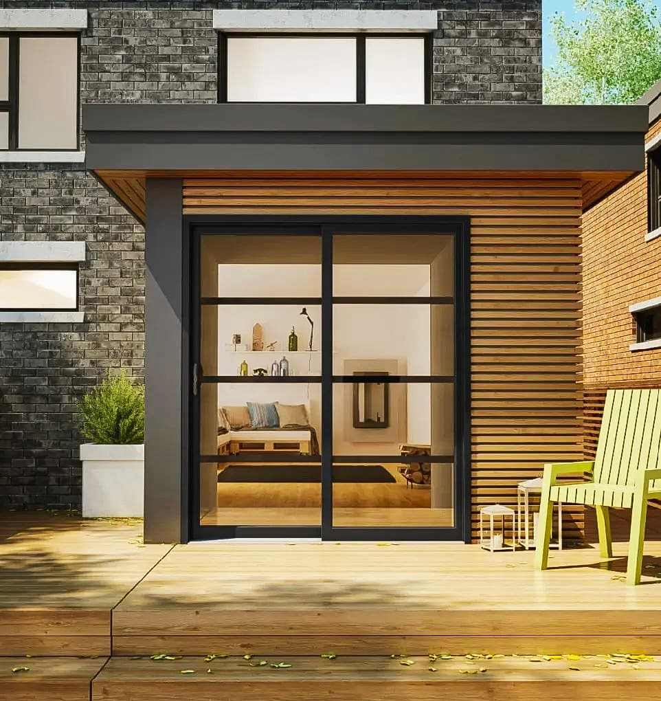 Modern facade of a contemporary house with black sliding glass door, wooden cladding, and a furnished deck.