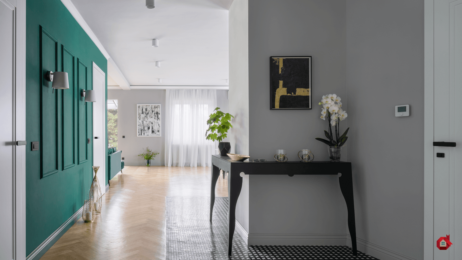 Elegant, modern entrance with deep green wall and herringbone parquet floor.
