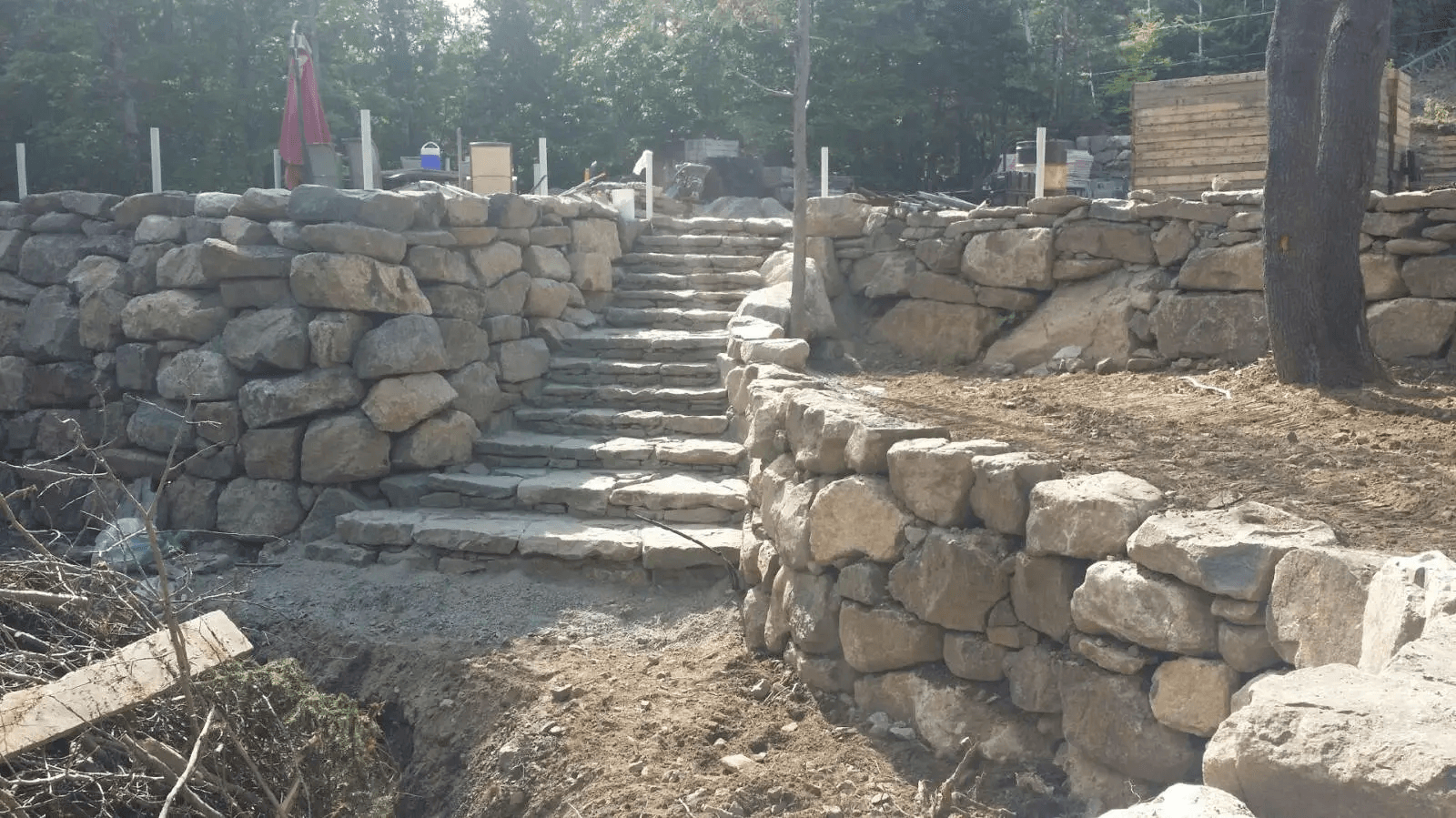 Outdoor stone staircase surrounded by rustic natural stone retaining walls